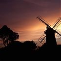 Silhouette of a windmill against the sunset