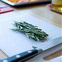 Chopping board with rosemary and knife